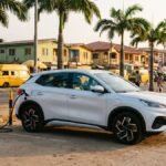 White electric SUV charging at a public EV charging station on a Lagos street in Nigeria